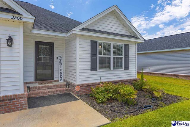 3209 Haven Straits, Florence, SC 29505 - doorway to property with a shingled roof and a yard