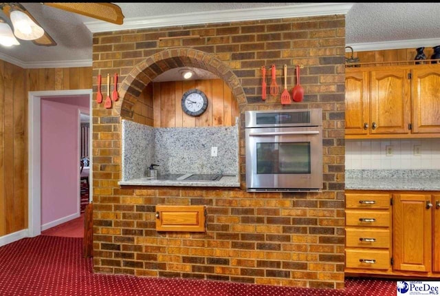 101 E Claff Cir, Lake City, SC 29501 - kitchen with crown molding, ceiling fan, a textured ceiling, dark carpet, and stainless steel oven