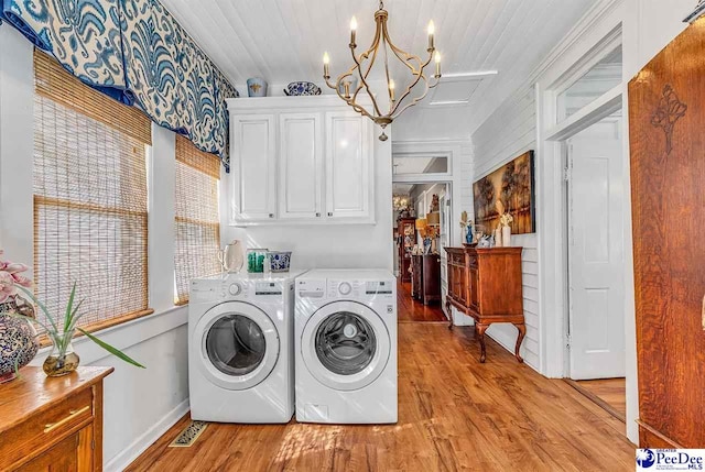 clothes washing area with wood ceiling, cabinets, a chandelier, light hardwood / wood-style flooring, and washing machine and dryer