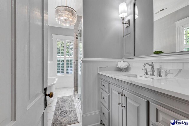 bathroom with crown molding, tile patterned flooring, and a wealth of natural light