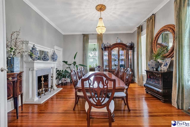 dining room with wood-type flooring and crown molding