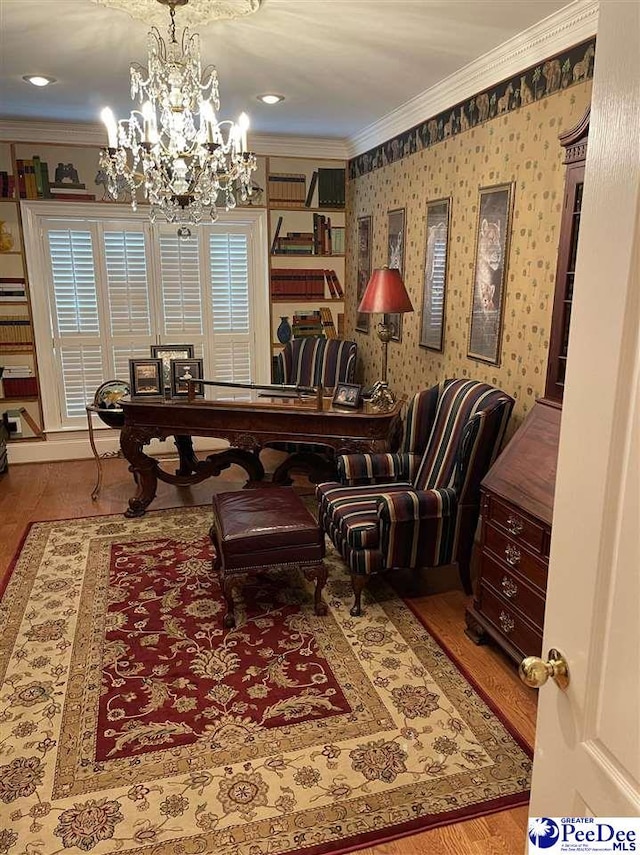 living area featuring a notable chandelier, crown molding, and light wood-type flooring