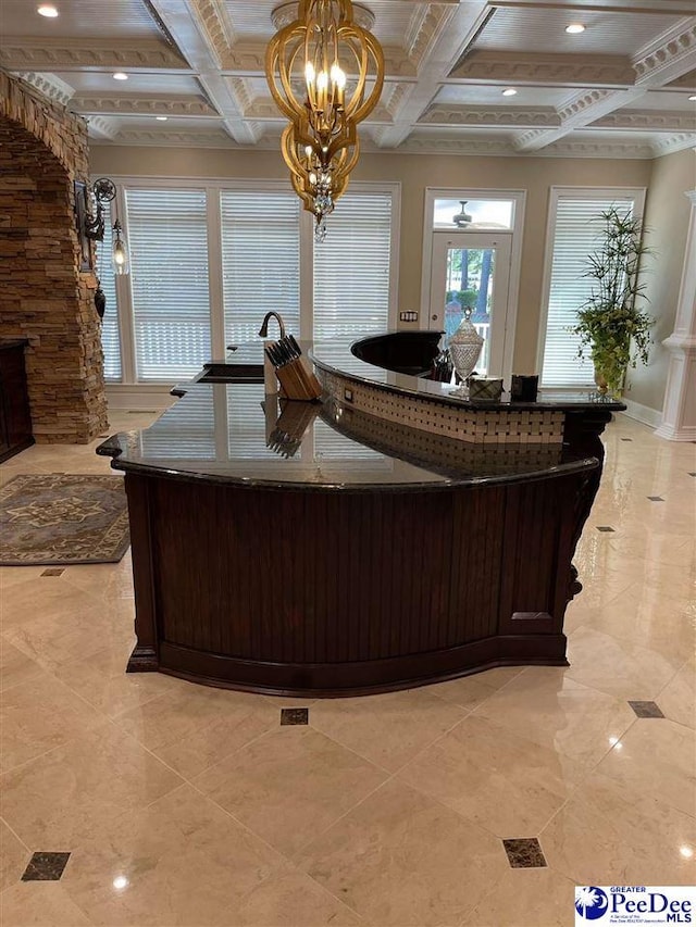 interior space with beamed ceiling, coffered ceiling, and sink