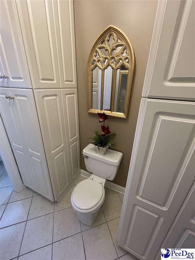 bathroom with toilet and tile patterned flooring