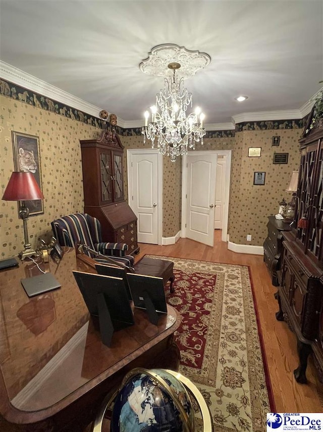 living room featuring a notable chandelier, crown molding, and light hardwood / wood-style floors