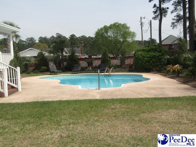 view of pool with a yard and a patio