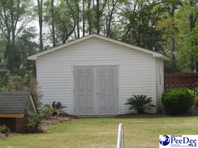 view of outdoor structure featuring a lawn