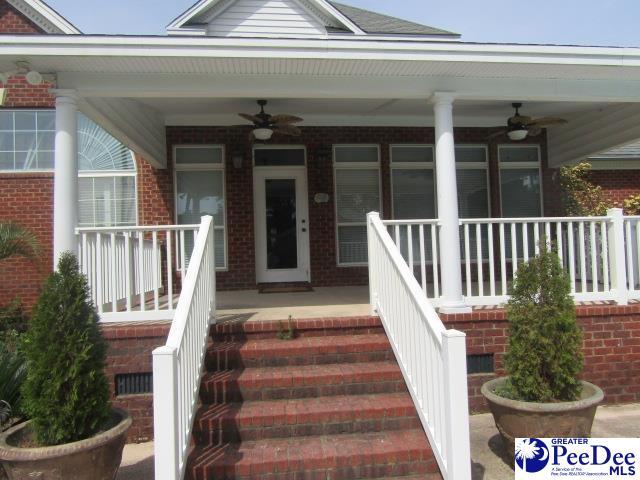 doorway to property with ceiling fan and covered porch