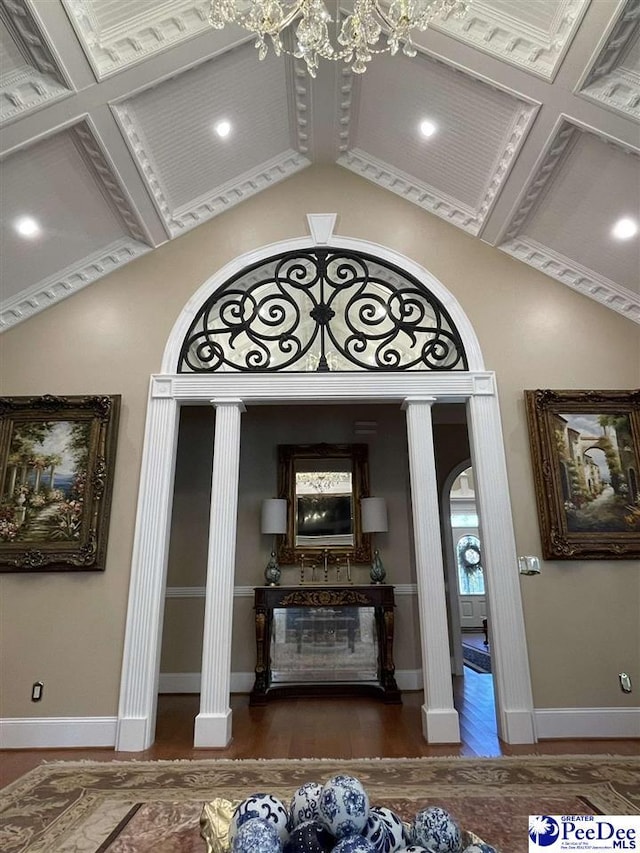 interior space featuring dark hardwood / wood-style flooring, a chandelier, and high vaulted ceiling