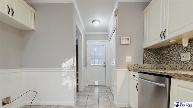 kitchen featuring tasteful backsplash, dishwasher, light stone countertops, and crown molding