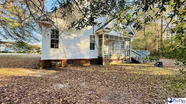 view of side of property with a sunroom