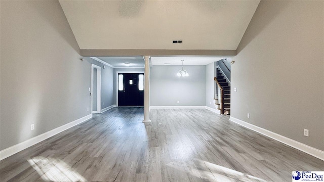 interior space with a chandelier and hardwood / wood-style floors