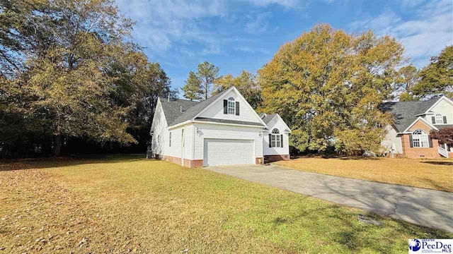 view of front of property featuring a garage and a front lawn