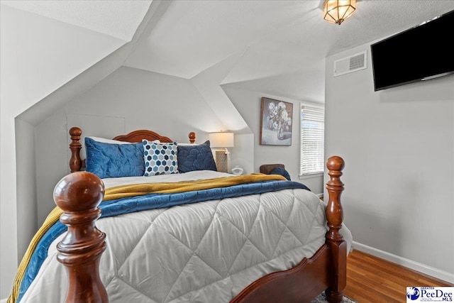 100 Mckellar St, Bennettsville, SC 29512 - bedroom with wood finished floors, vaulted ceiling, and baseboards