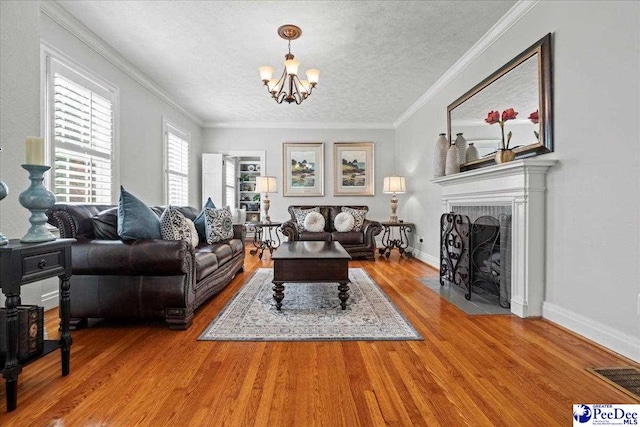100 Mckellar St, Bennettsville, SC 29512 - living area with a chandelier, wood finished floors, a textured ceiling, a brick fireplace, and baseboards