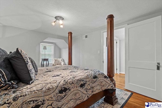 100 Mckellar St, Bennettsville, SC 29512 - bedroom with light wood-style floors and a textured ceiling