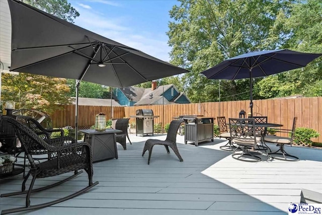 100 Mckellar St, Bennettsville, SC 29512 - wooden terrace featuring area for grilling, a fenced backyard, and outdoor dining area