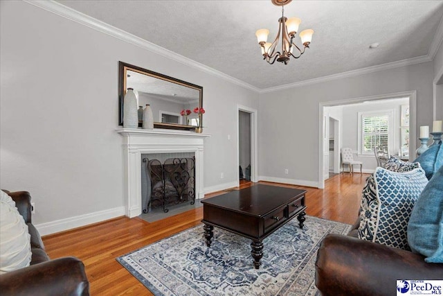 100 Mckellar St, Bennettsville, SC 29512 - living area featuring a chandelier, wood finished floors, ornamental molding, baseboards, and a fireplace with flush hearth