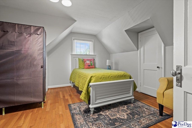 100 Mckellar St, Bennettsville, SC 29512 - bedroom with wood finished floors, lofted ceiling, and baseboards