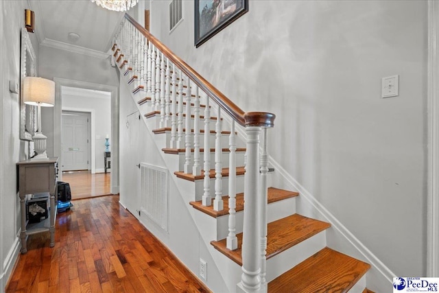 100 Mckellar St, Bennettsville, SC 29512 - stairway with crown molding and hardwood / wood-style flooring