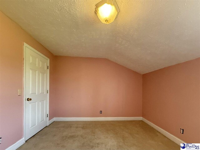 148 High Hill Rd, Lake View, SC 29563 - additional living space featuring a textured ceiling, vaulted ceiling, and light colored carpet