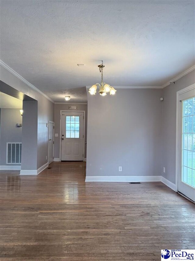 148 High Hill Rd, Lake View, SC 29563 - unfurnished room featuring a chandelier, dark wood finished floors, plenty of natural light, ornamental molding, and a textured ceiling