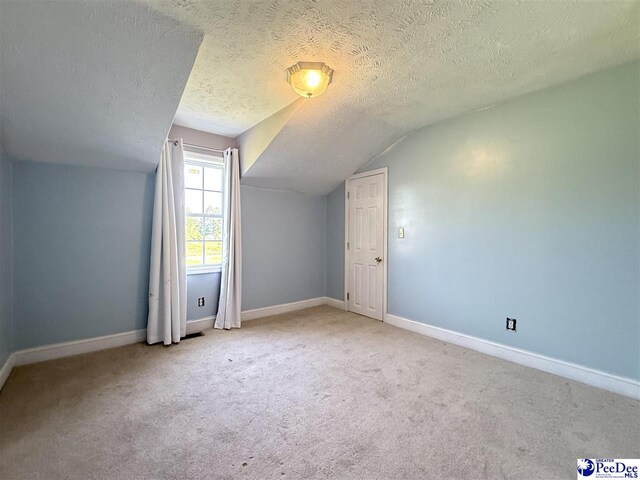 148 High Hill Rd, Lake View, SC 29563 - additional living space with vaulted ceiling, carpet floors, and a textured ceiling