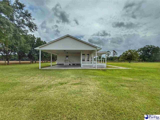 148 High Hill Rd, Lake View, SC 29563 - back of house featuring a yard and an attached carport