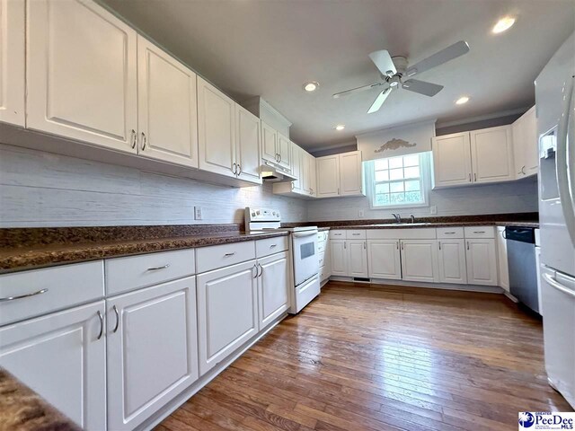 148 High Hill Rd, Lake View, SC 29563 - kitchen featuring white appliances, white cabinets, dark countertops, hardwood / wood-style flooring, and recessed lighting