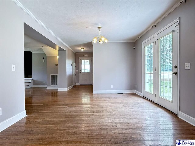 148 High Hill Rd, Lake View, SC 29563 - unfurnished dining area featuring crown molding, wood finished floors, a chandelier, and a textured ceiling
