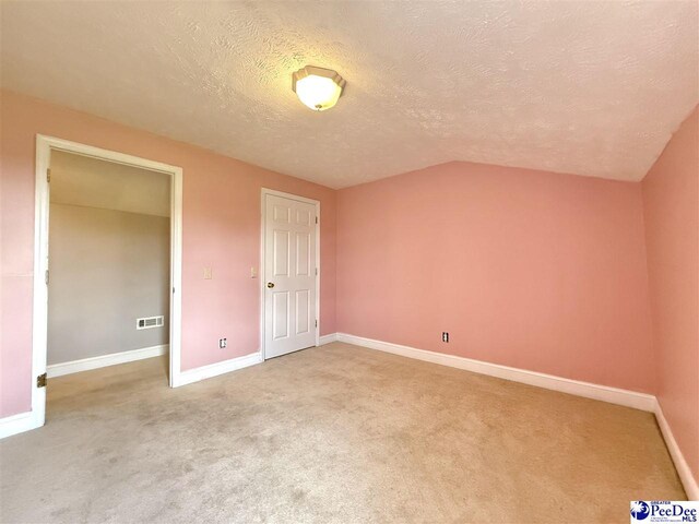 148 High Hill Rd, Lake View, SC 29563 - unfurnished bedroom featuring a textured ceiling, light colored carpet, and lofted ceiling