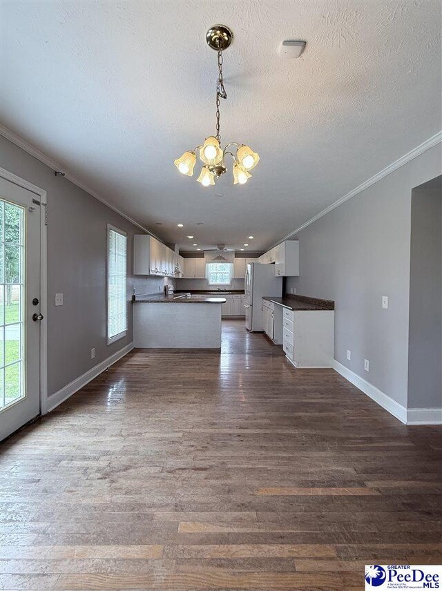 148 High Hill Rd, Lake View, SC 29563 - kitchen featuring a chandelier, dark countertops, a peninsula, freestanding refrigerator, and crown molding