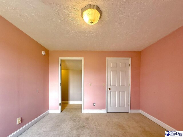 148 High Hill Rd, Lake View, SC 29563 - unfurnished bedroom featuring light carpet and a textured ceiling