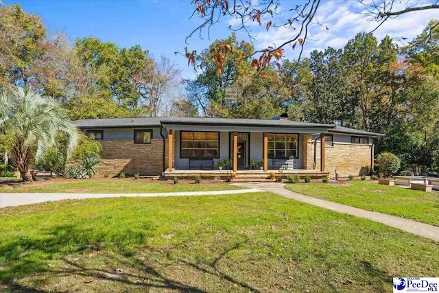 view of front of house with covered porch and a front yard