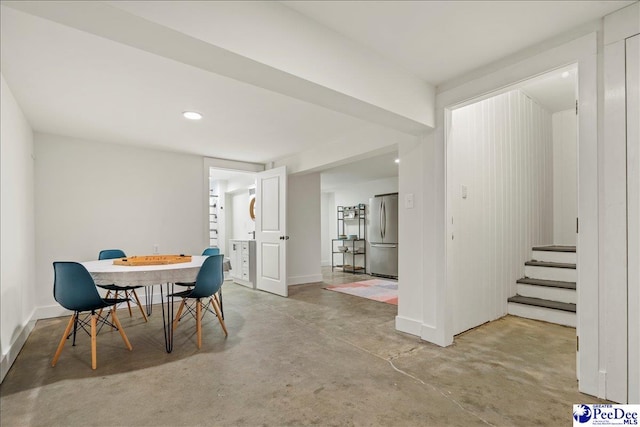 dining space featuring concrete flooring