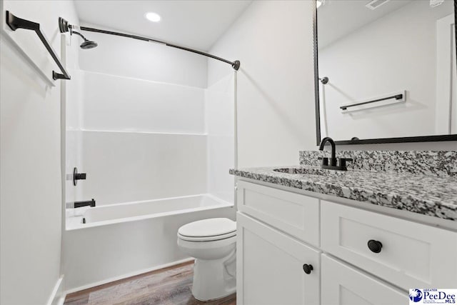 full bathroom featuring vanity, hardwood / wood-style flooring,  shower combination, and toilet