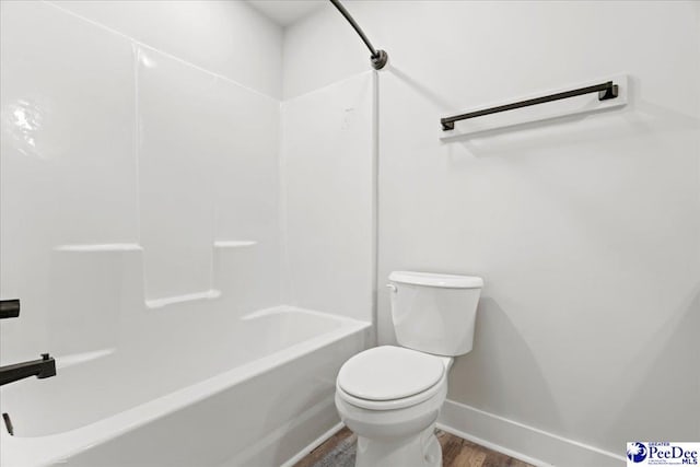 bathroom featuring hardwood / wood-style flooring and toilet