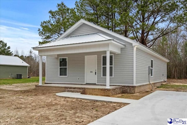 view of front of home featuring a porch and central AC