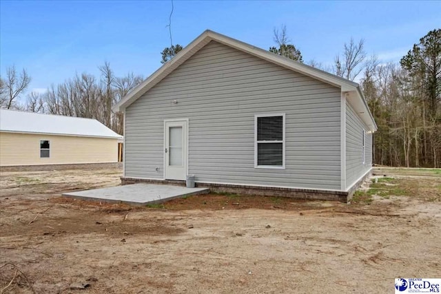 back of house with a patio