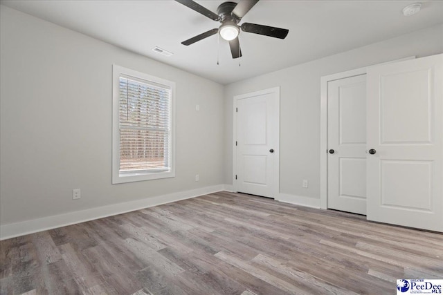 unfurnished bedroom with light hardwood / wood-style flooring and ceiling fan