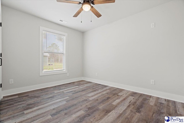 spare room featuring hardwood / wood-style flooring and ceiling fan