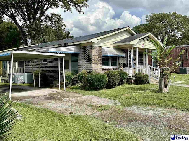 view of front facade with a carport, central AC unit, and a front yard