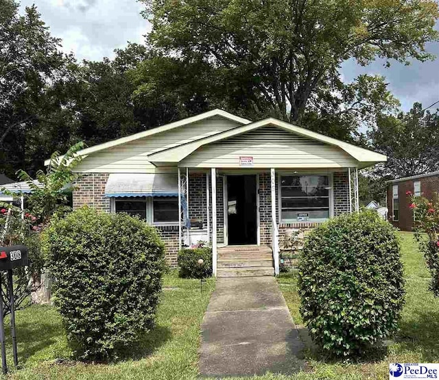 bungalow-style house featuring a front yard