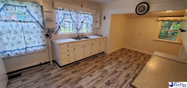 107 Patterson St, Bennettsville, SC 29512 - kitchen with a sink, wood finished floors, white cabinetry, light countertops, and open shelves