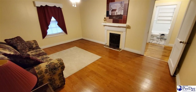 107 Patterson St, Bennettsville, SC 29512 - living room featuring a fireplace, wood finished floors, and baseboards