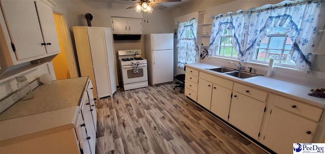 107 Patterson St, Bennettsville, SC 29512 - kitchen with white appliances, a sink, white cabinetry, light wood finished floors, and a ceiling fan
