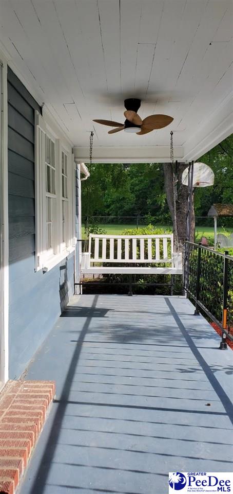 107 Patterson St, Bennettsville, SC 29512 - wooden porch with a ceiling fan