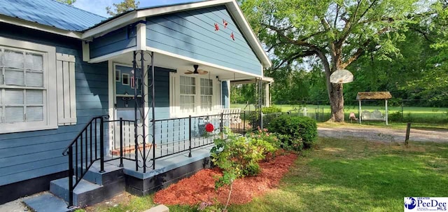 107 Patterson St, Bennettsville, SC 29512 - view of side of property featuring covered porch, metal roof, and a yard