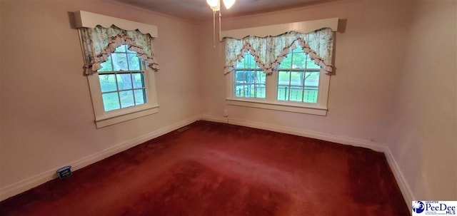 107 Patterson St, Bennettsville, SC 29512 - empty room with baseboards, dark colored carpet, and ceiling fan