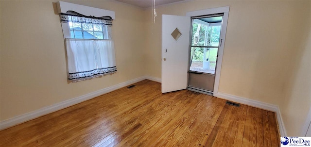 107 Patterson St, Bennettsville, SC 29512 - unfurnished room featuring light wood-type flooring, baseboards, and crown molding